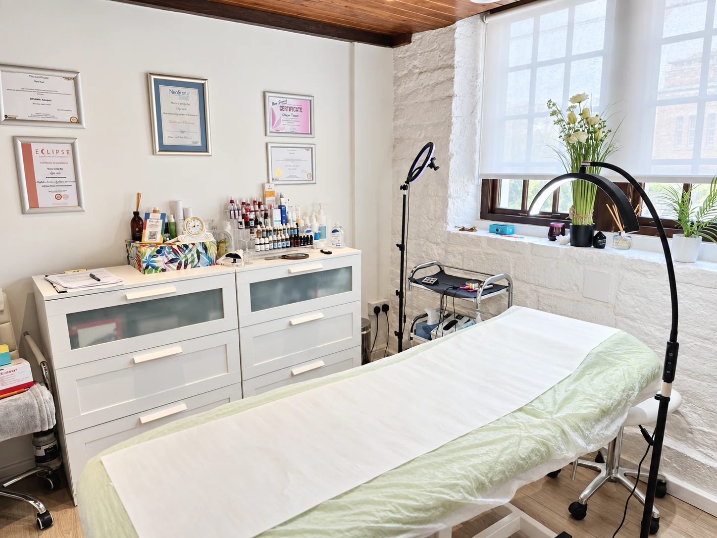 Olya’s Trowbridge treatment room with a treatment couch, lighting and equipment.
